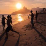 Rio de Janeiro, Brazil - February 13 2014: Young men throwing ball on beach during sunset